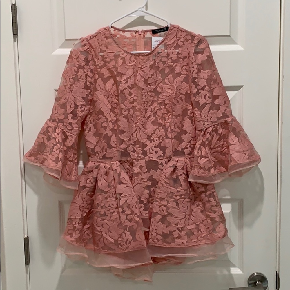 Peplum top with back zipper and bell sleeves.